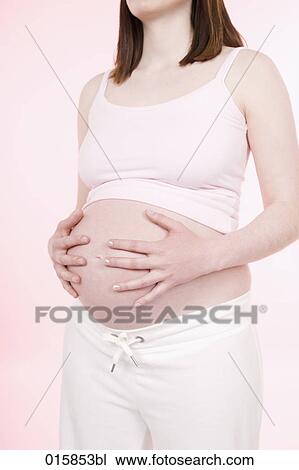 detail of pregnant young woman holding her belly View Large Photo Image Stock Image - detail of pregnant young woman holding her belly. Fotosearch
