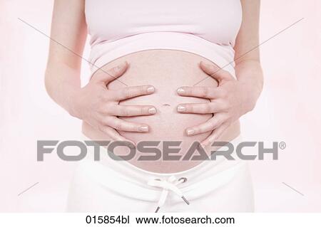 detail of pregnant young woman holding her belly View Large Photo Image Stock Image - detail of pregnant young woman holding her belly. Fotosearch