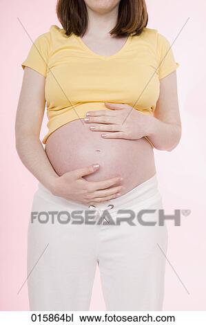 detail of pregnant young woman holding her belly View Large Photo Image Stock Image - detail of pregnant young woman holding her belly. Fotosearch
