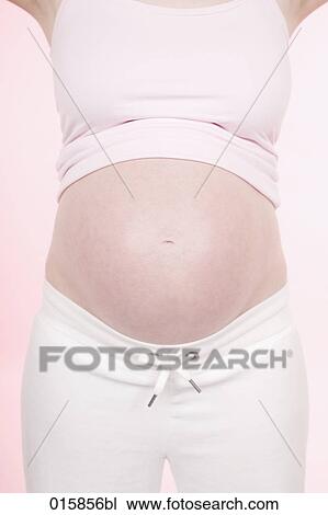 detail of pregnant young woman showing her belly View Large Photo Image Stock Image - detail of pregnant young woman showing her belly. Fotosearch