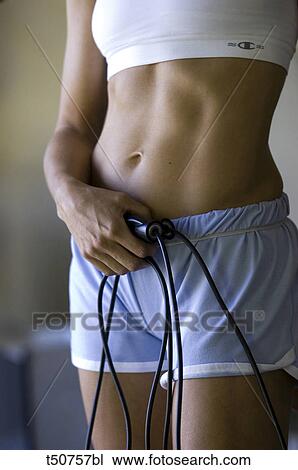Detail of woman working out with a jump rope View Large Photo Image Stock Image - Detail of woman working out with a jump rope. Fotosearch