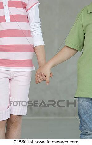 detail of young boy and girl holding hands View Large Photo Image Stock Image - detail of young boy and girl holding hands. Fotosearch