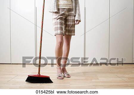 detail of young woman holding broom and dustpan View Large Photo Image Stock Image - detail of young woman holding broom and dustpan. Fotosearch