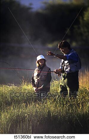 Father fly fishing with his daughter View Large Photo Image Stock Image - Father fly fishing with his daughter. Fotosearch