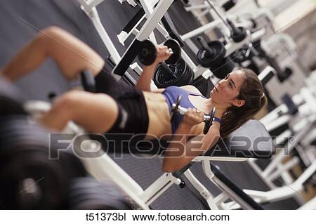 Female working out with free weights View Large Photo Image Stock Image - Female working out with free weights. Fotosearch