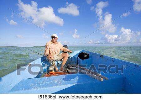 Fly fisherman in small boat on Abaco, Bahamas View Large Photo Image Stock Image - Fly fisherman in small boat on Abaco, Bahamas. Fotosearch