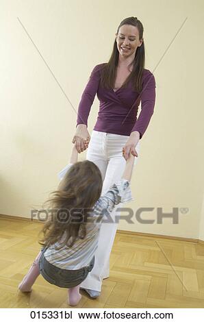 full body portrait of mother dancing with her little daughter View Large Photo Image Stock Image - full body portrait of mother dancing with her little daughter. Fotosearch