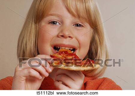 Stock Image - Girl eating pizza. Fotosearch