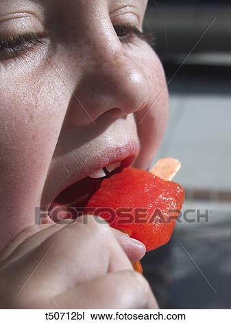 Girl eating popsicle View Large Photo Image Stock Image - Girl eating popsicle. Fotosearch