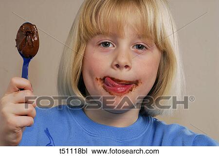 Stock Image - Girl holding a spoon with chocolate. Fotosearch