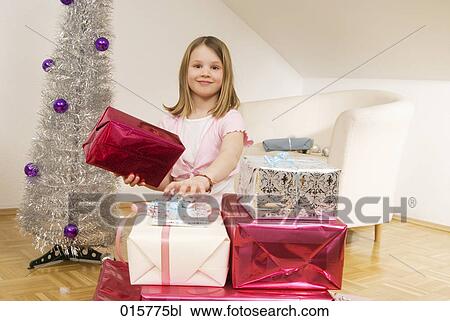 girl in living room surrounded by christmas presents View Large Photo Image Stock Image - girl in living room surrounded by christmas presents. Fotosearch