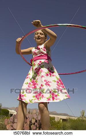 Girl playing with hula hoop View Large Photo Image Stock Image - Girl playing with hula hoop. Fotosearch