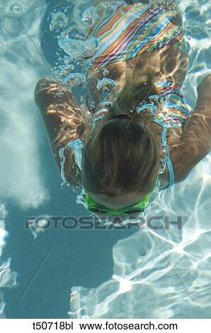 Girl swimming underwater in pool View Large Photo Image Stock Image - Girl swimming underwater in pool. Fotosearch