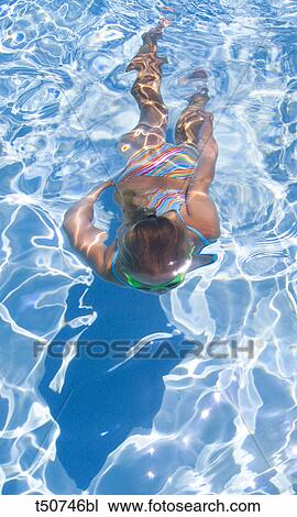 Girl swimming underwater View Large Photo Image Stock Image - Girl swimming underwater. Fotosearch
