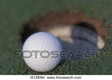 Golf ball entering hole View Large Photo Image Stock Image - Golf ball entering hole. Fotosearch