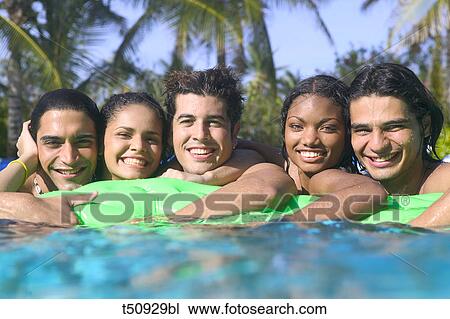 Group of young friends in swimming pool View Large Photo Image Stock Image - Group of young friends in swimming pool. Fotosearch