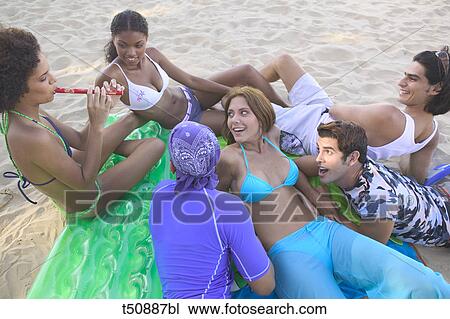 Group of young people on the beach View Large Photo Image Stock Image - Group of young people on the beach. Fotosearch