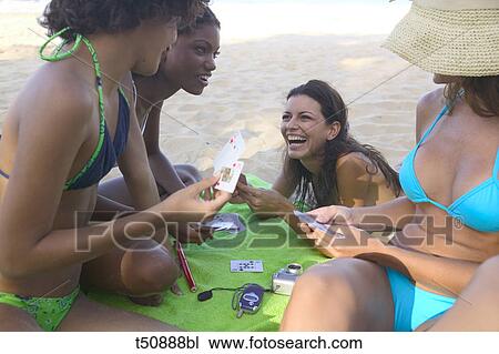 Group of young people playing cards on the beach View Large Photo Image Stock Image - Group of young people playing cards on the beach. Fotosearch