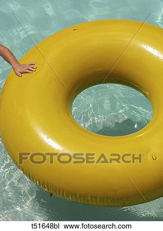 Hand and yellow inflatable ring in a pool View Large Photo Image Stock Image - Hand and yellow inflatable ring in a pool. Fotosearch