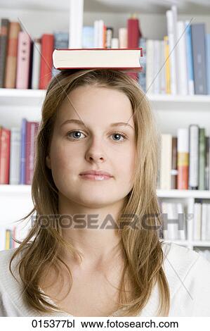 headshot of teenage girl balancing book on head View Large Photo Image Stock Image - headshot of teenage girl balancing book on head. Fotosearch