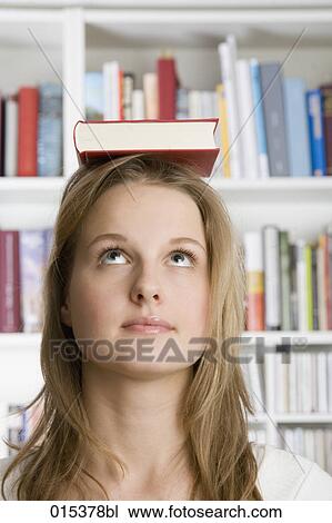 headshot of teenage girl balancing book on head View Large Photo Image Stock Image - headshot of teenage girl balancing book on head. Fotosearch