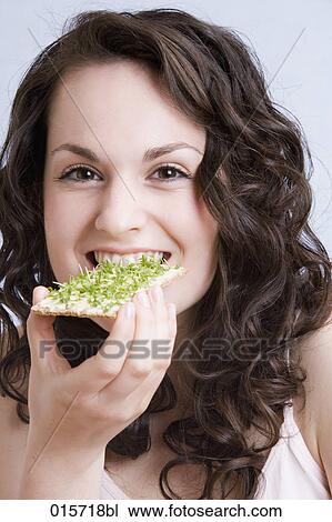 headshot of young woman enjoying crisp bread with cress View Large Photo Image Stock Image - headshot of young woman enjoying crisp bread with cress. Fotosearch