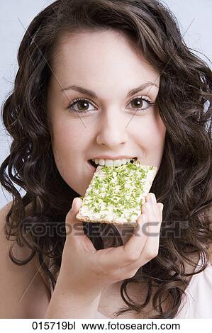 headshot of young woman enjoying crisp bread with cress View Large Photo Image Stock Image - headshot of young woman enjoying crisp bread with cress. Fotosearch