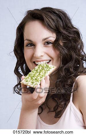headshot of young woman enjoying crisp bread with cress View Large Photo Image Stock Image - headshot of young woman enjoying crisp bread with cress. Fotosearch