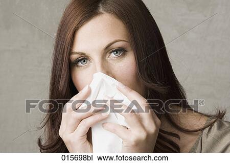 headshot of young woman with tissue View Large Photo Image Stock Image - headshot of young woman with tissue. Fotosearch