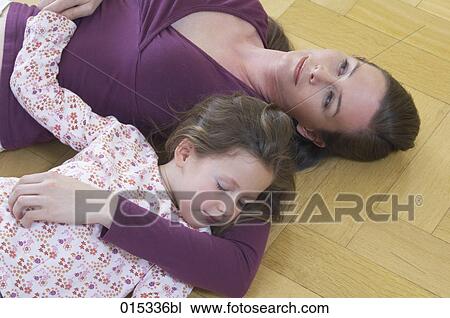 high angle view of mother and daughter lying floor little girl sleeping View Large Photo Image Stock Image - high angle view of mother and daughter lying floor little girl sleeping. Fotosearch