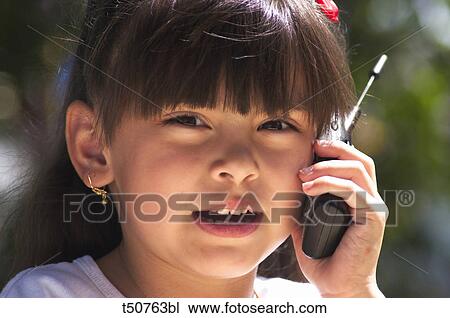 Hispanic girl on cell phone View Large Photo Image Stock Image - Hispanic girl on cell phone. Fotosearch