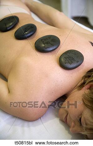 Stock Image - Hot stone therapy. Fotosearch