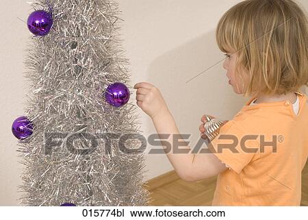 little girl decorating christmas tree View Large Photo Image Stock Image - little girl decorating christmas tree. Fotosearch
