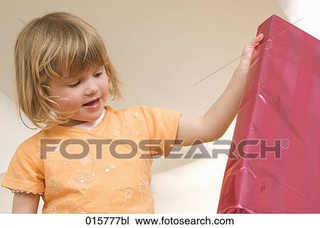 little girl looking at big present View Large Photo Image Stock Image - little girl looking at big present. Fotosearch