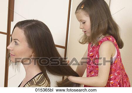 little girl making her mother´s hair View Large Photo Image Stock Image - little girl making her mother´s hair. Fotosearch