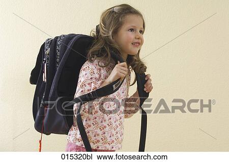 Stock Image - little girl with satchel ready to go to school. Fotosearch