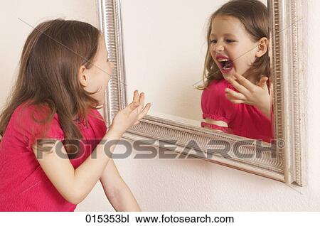 made-up young girl laughing at herself in mirror View Large Photo Image Stock Image - made-up young girl laughing at herself in mirror. Fotosearch