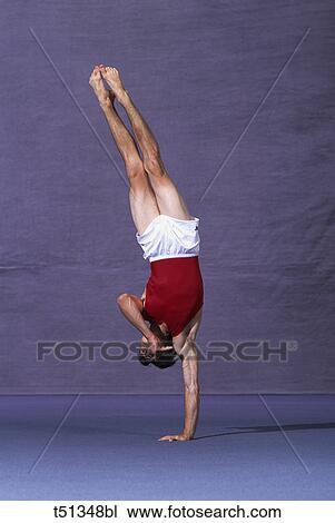 Male gymnast performing on the floor exercise View Large Photo Image Stock Image - Male gymnast performing on the floor exercise. Fotosearch
