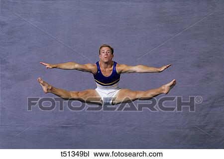 Male gymnast performing on the floor exercise View Large Photo Image Stock Image - Male gymnast performing on the floor exercise. Fotosearch