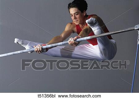 Male gymnast performing on the high bar View Large Photo Image Stock Image - Male gymnast performing on the high bar. Fotosearch
