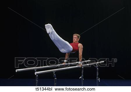 Male gymnast performing on the parallel bars View Large Photo Image Stock Image - Male gymnast performing on the parallel bars. Fotosearch