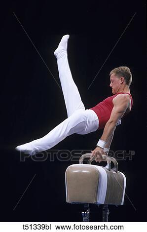 Male gymnast performing on the pomell horse View Large Photo Image Stock Image - Male gymnast performing on the pomell horse. Fotosearch