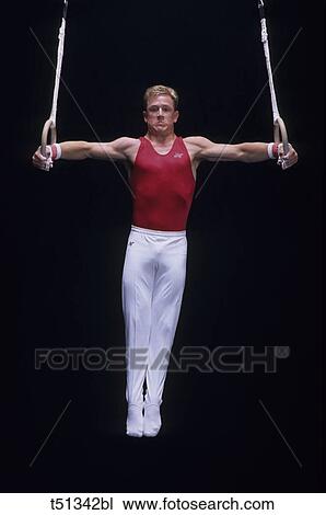 Male gymnast performing on the rings View Large Photo Image Stock Image - Male gymnast performing on the rings. Fotosearch