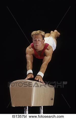 Male gymnast performing on the vaulting horse View Large Photo Image Stock Image - Male gymnast performing on the vaulting horse. Fotosearch