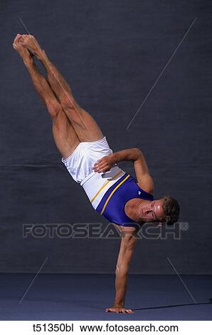 Male gymnast performing the floor exercise View Large Photo Image Stock Image - Male gymnast performing the floor exercise. Fotosearch