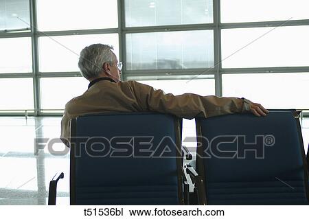 Man at airport waiting lounge View Large Photo Image Stock Image - Man at airport waiting lounge. Fotosearch
