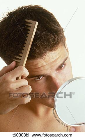 Stock Image - Man combing hair. Fotosearch
