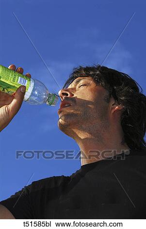 Man drinking from bottle View Large Photo Image Stock Image - Man drinking from bottle. Fotosearch