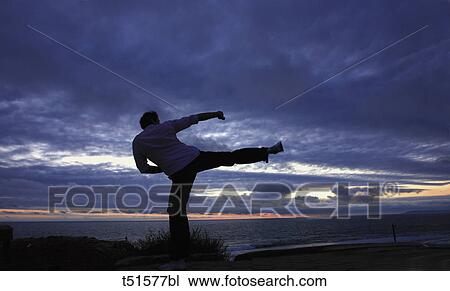 Man exercising at sunset View Large Photo Image Stock Image - Man exercising at sunset. Fotosearch