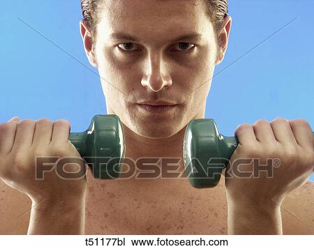 Man exercising with dumbbells View Large Photo Image Stock Image - Man exercising with dumbbells. Fotosearch